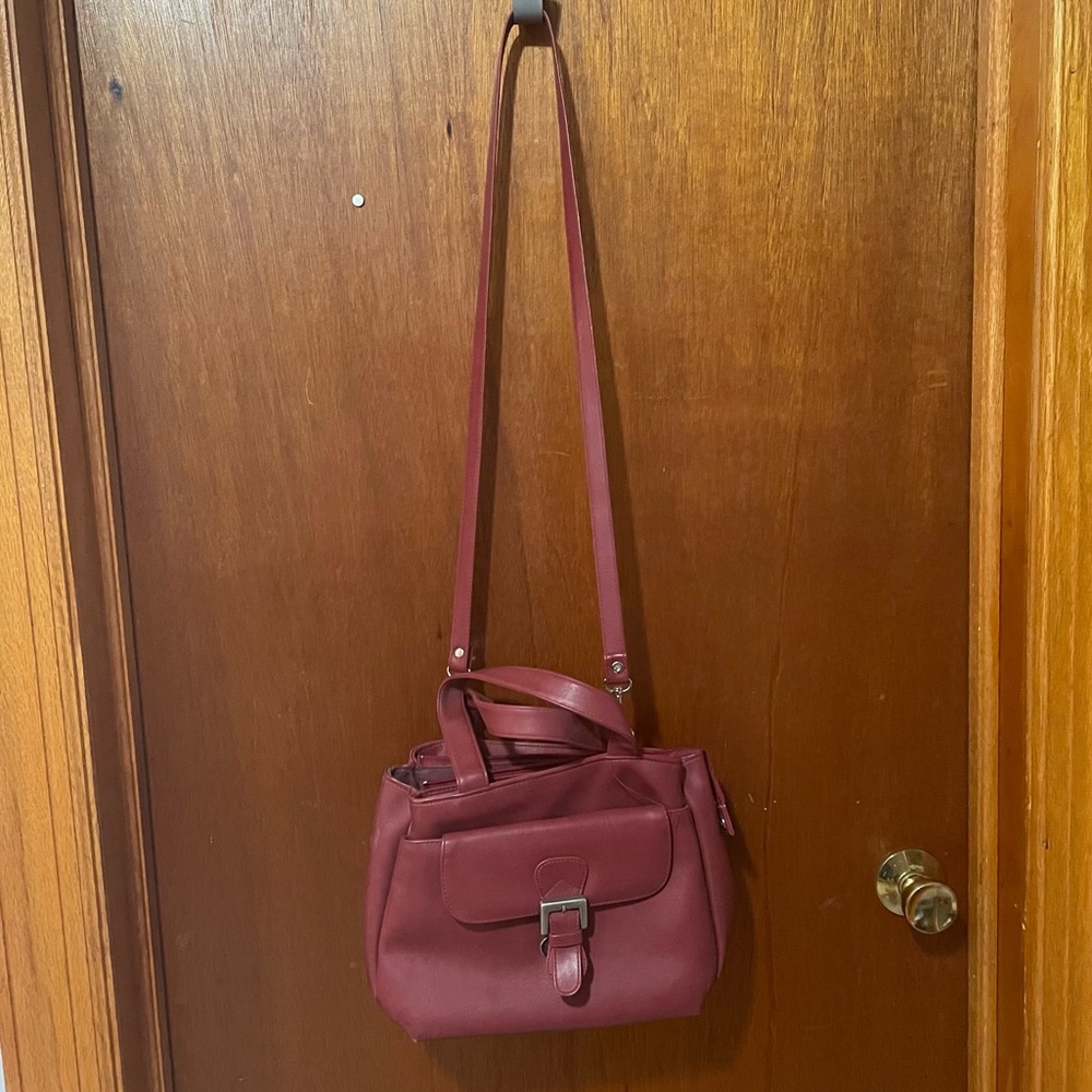 Red Cross body bag with handles, three main compartments and detachable key fob